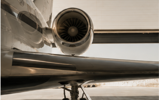 Aircraft engine and wing detail inside a quiet hangar